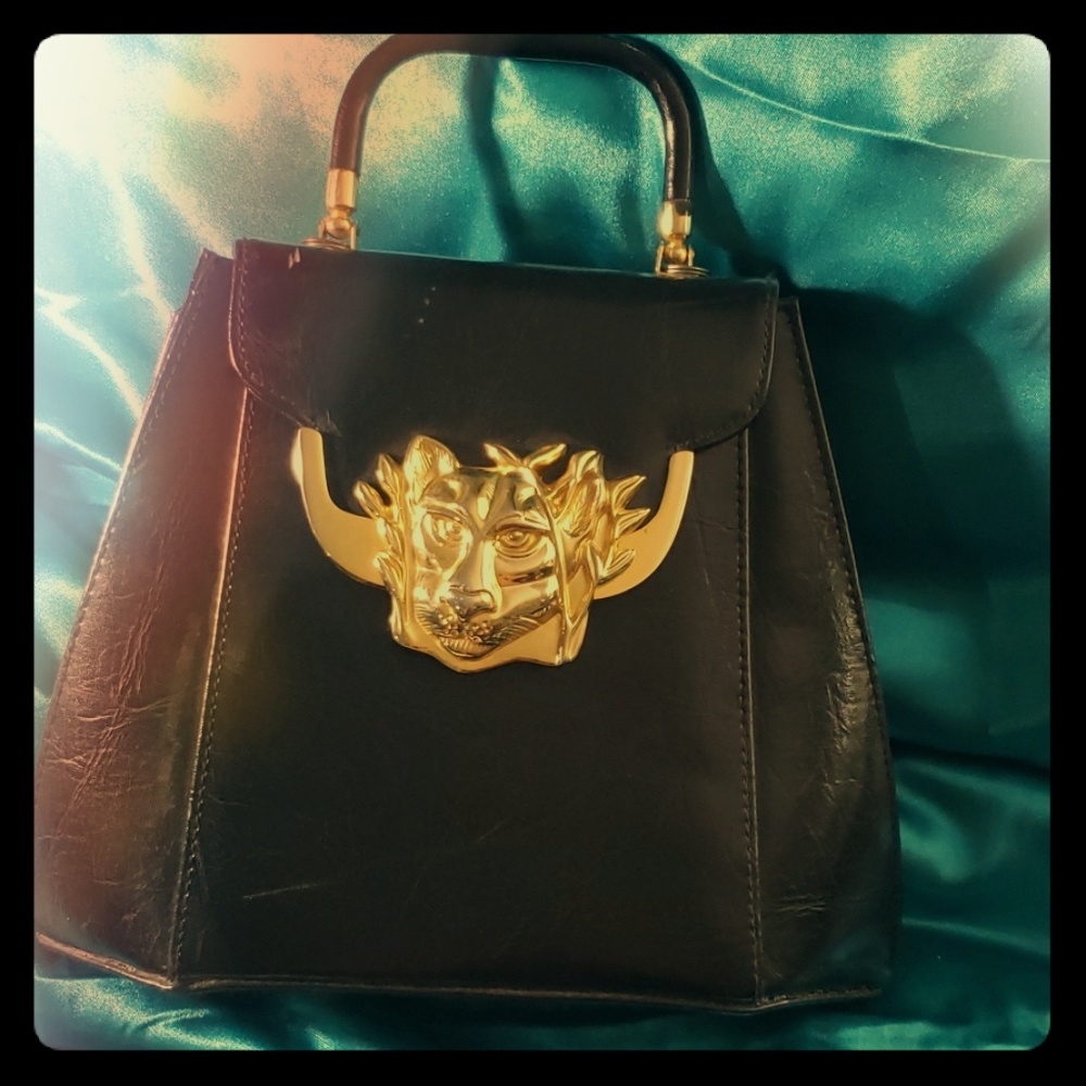 Black hand bag with metal lion clasp